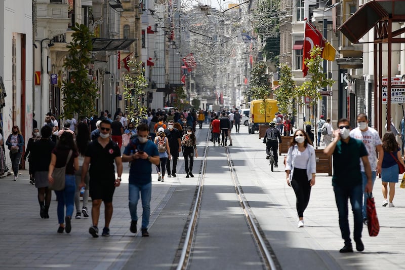 People walk on Istiklal street, the main shopping street in Istanbul, a few hours before the weekend lockdown due to the coronavirus. Teenagers were able to leave their homes for the first time in 42 days on Friday, as their turn came for a few hours of respite from Turkey's coronavirus lockdowns. Turkey has subjected people aged 65 and over and those younger than 20, to a curfew for the past several weeks.  AP Photo