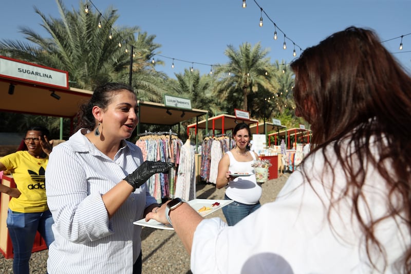 Aimee tries samples from Salma Nizam from @TheDipStop.UAE at the Saturday Market