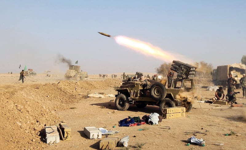 Shiite fighters from the Hashed al-Shaabi (Popular Mobilisation) launches missiles on the village of Salmani, south of Mosul, on October 30, 2016 during the ongoing battle against Islamic State group jihadists to liberate the city of Mosul. - Iraqi paramilitary forces said they had captured several villages southwest of Mosul from the Islamic State group on Sunday, the second day of an operation to cut the jihadists' supply lines. (Photo by AHMAD AL-RUBAYE / AFP)