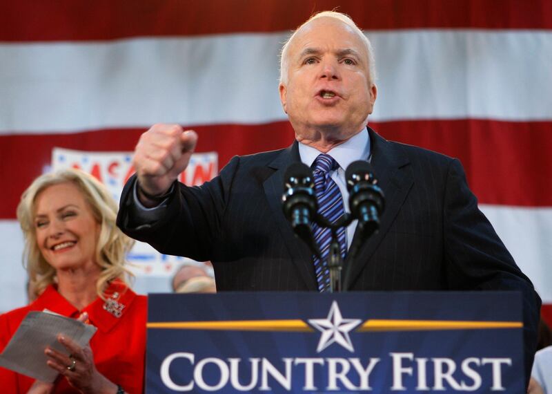 Republican presidential candidate John McCain, standing with his wife Cindy, encourages his supporters to stand up and fight for America during a campaign rally in Bensalem, Pennsylvania., on October 21, 2008. AP Photo