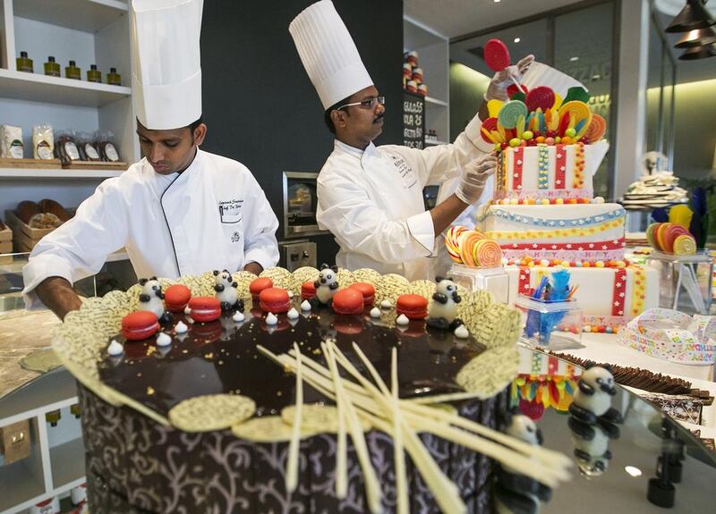 The Hilton’s award winning executive pastry chef, Praveen Kumar, right, and his team have created a replica model of the Grand Mosque to mark the holy month of Ramadan. Mona Al Marzooqi / The National 