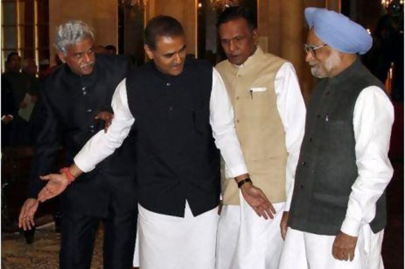 Left to right, the cabinet ministers Sriprakash Jaiswal, Praful Patel and Beni Prasad Verma make way for Manmohan Singh, the prime minister, at yesterday's swearing-in ceremony in New Delhi.