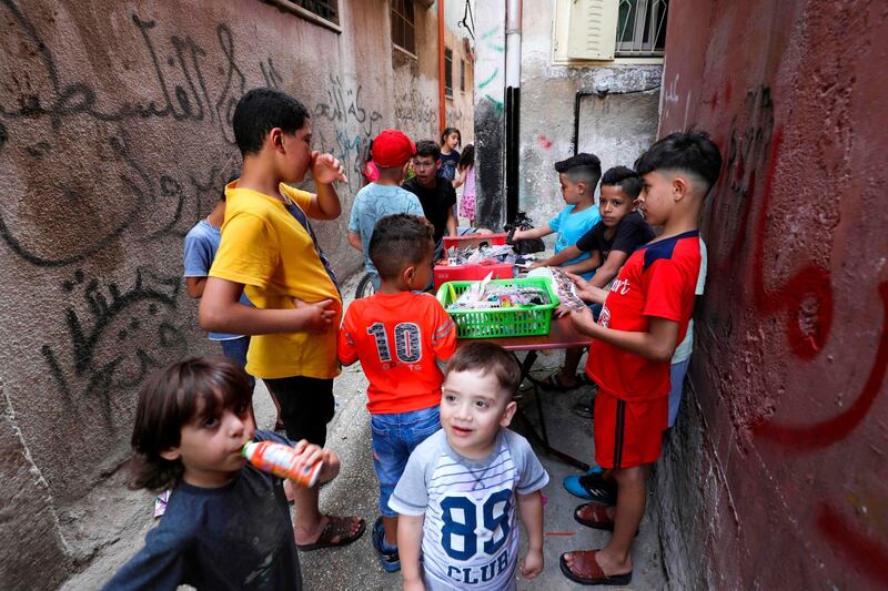 Palestinian children gather around a street vendor in the Amari refugee camp near the West Bank city of Ramallah.  AFP