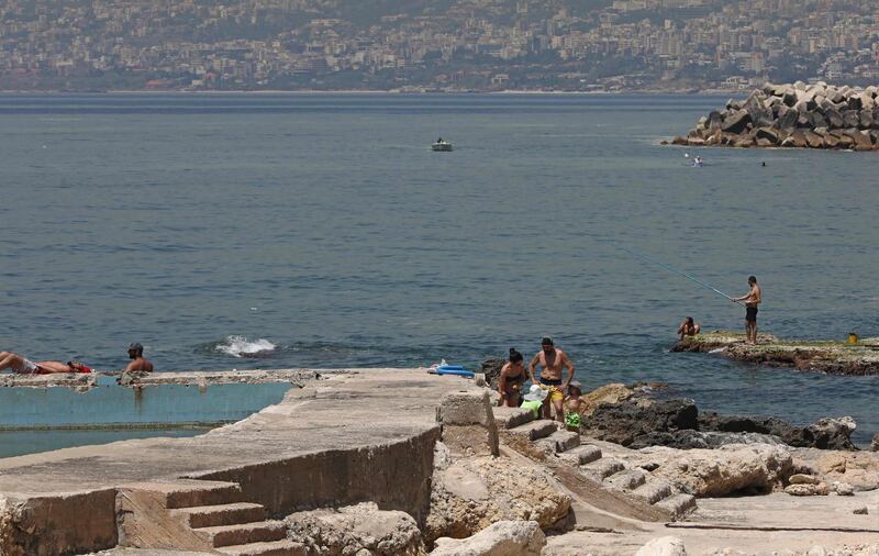 People gather on a beach in the Lebanese coastal village of Safra despite a four-day nationwide lockdown.  AFP