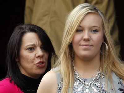 Bethany Haines, right, leaving a memorial service to her father David Haines. Alamy