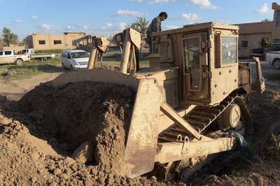 Somar Ahmed, a 31-year-old minesweeper driver, stands on his bulldozer near the last ISIS enclave of Baghouz. Campbell MacDiarmid