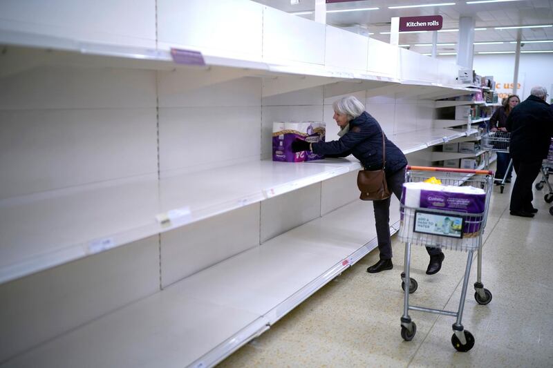 A senior citizen gets the last pack of toilet rolls at Sainsbury's Supermarket in Northwich, northern England. Getty Images