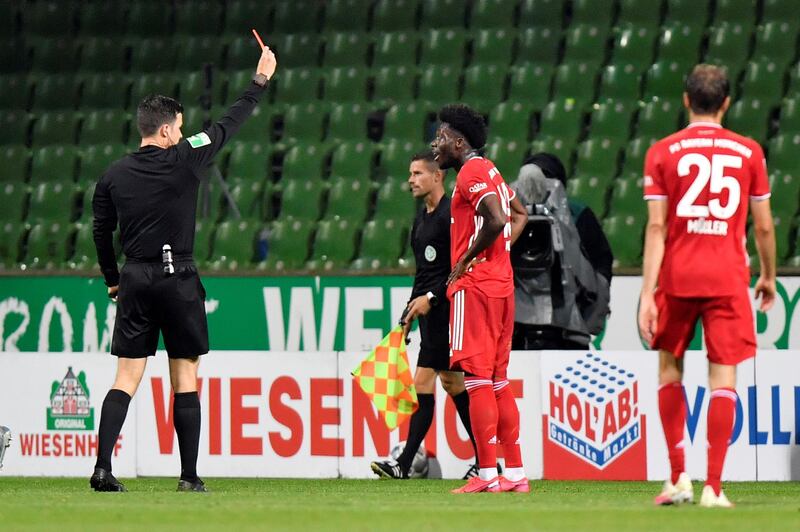 Referee Harm Osmers shows the red card to Bayern Munich's Alphonso Davies. Reuters