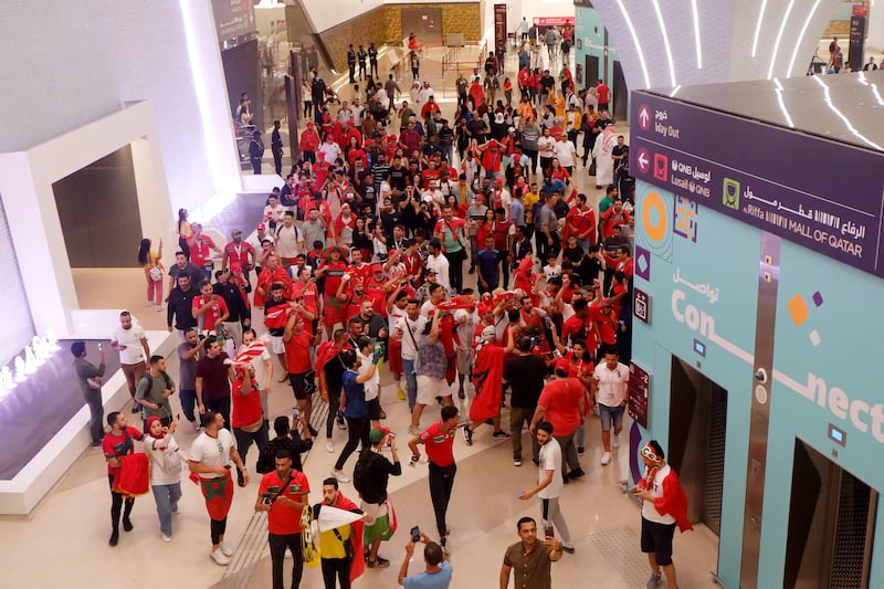 People celebrate at Msheireb Metro Station in Doha, Qatar, after Morocco beat Spain in a penalty shootout at the Fifa World Cup on Tuesday. Getty