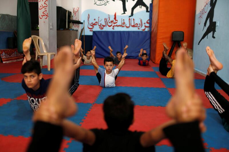 Palestinian boys perform during a yoga and flexibility class on International Yoga Day amid the coronavirus crisis, in a club in Gaza City. Reuters