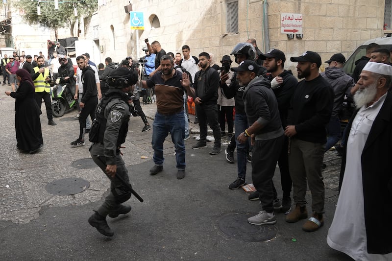 Officers try to disperse Palestinians in the Al Aqsa Mosque compound. AP