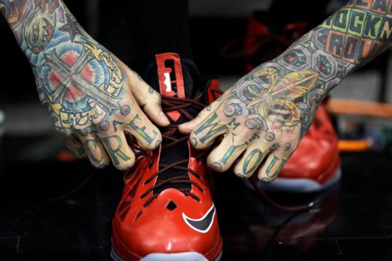 Miami Heat's Chris Andersen ties his shoes during NBA basketball practice, Saturday, June 15, 2013, in San Antonio. The Heat take on the San Antonio Spurs in Game 5 of the NBA Finals on Sunday, with the best-of-seven games series even at 2-2. (AP Photo/David J. Phillip)