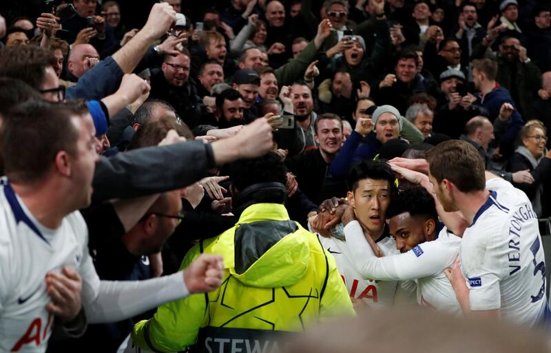 Tottenham's Son Heung-min celebrates scoring their first goal with team mates and fans. Reuters