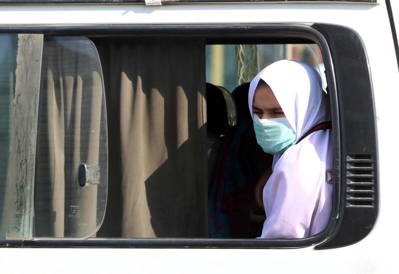 People wear face masks as they ride a bus after the first case of the Omicron variant was detected in Pakistan. The case was reported in a private hospital in Karachi by a patient with a history of international travel. EPA