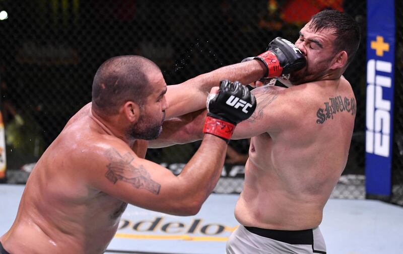 Blagoy Ivanov of Bulgaria (red gloves) punches Augusto Sakai of Brazil (blue gloves) in their heavyweight fight during UFC Fight Night. Zuffa