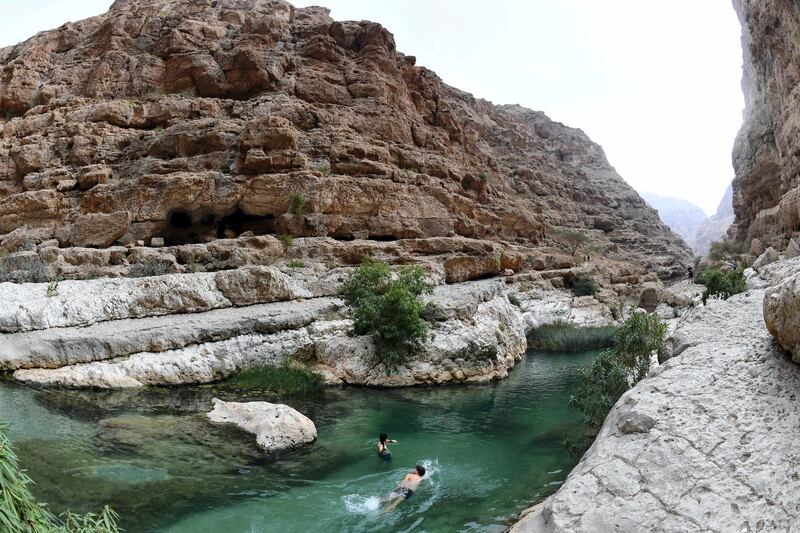 Tourists swim at Wadi Shab in the Sharqiyah region near the Omani capital Muscat on November 27, 2018. (Photo by GIUSEPPE CACACE / AFP)