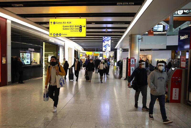 LONDON, ENGLAND - OCTOBER 20:  Passengers are pictured preparing to travel by air wearing protective masks on October 20, 2020 at Heathrow Terminal 5 Airport in London, United Kingdom. The British government is being pressed to create a covid-19 testing system to ease restrictions on inbound and outbound travelers. (Photo by Warren Little/Getty Images)