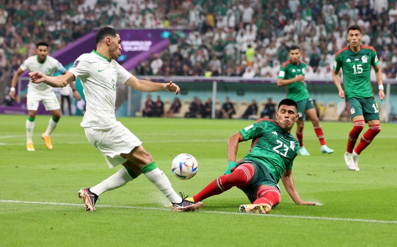 Saudi Arabia's Sultan Al Ghannam in action with Mexico's Jesus Gallardo. Reuters