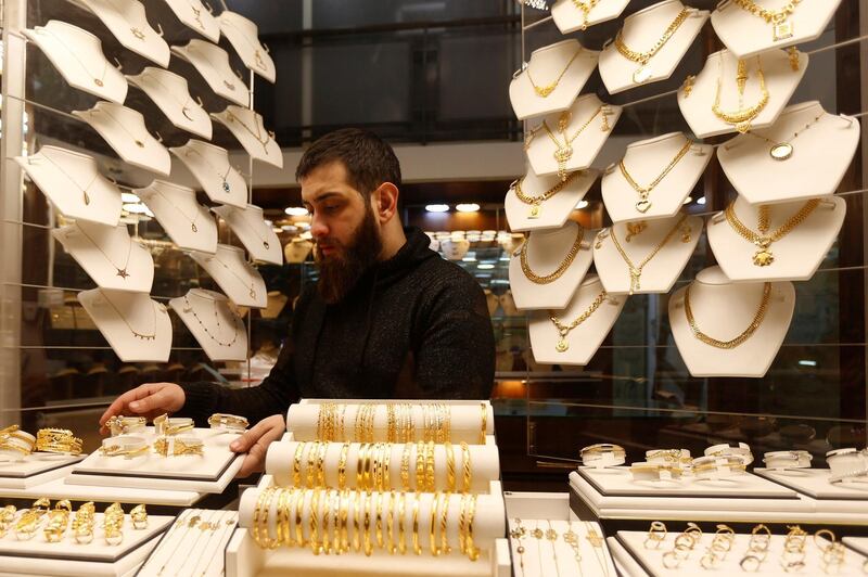 A salesman arranges gold bracelets inside a jewellery shop in Beirut, Lebanon. REUTERS