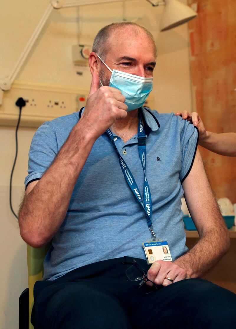 Professor Andrew Pollard, Director of the Oxford Vaccine Group, receives the Oxford University/AstraZeneca vaccine from nurse Sam Foster, at the Churchill Hospital in Oxford. AP Photo