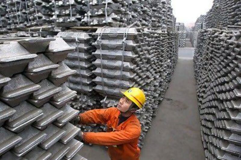 Aluminium ingots are stocked at Qingdao port in China's Shandong province. Mubadala has invested in a plant producing calcined petroleum coke, which is used in aluminium smelting. Reuters