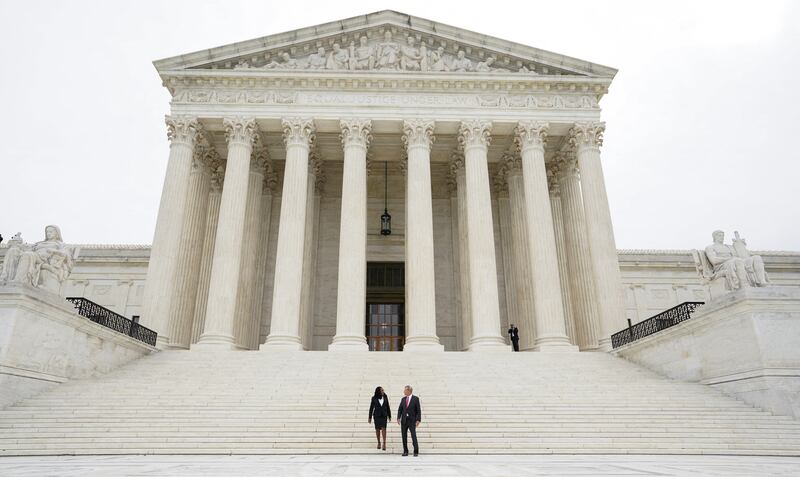 US Supreme Court Associate Justice Ketanji Brown Jackson and Chief Justice John Roberts on the front steps of the Court building following her investiture ceremony in Washington, on September 30. Reuters