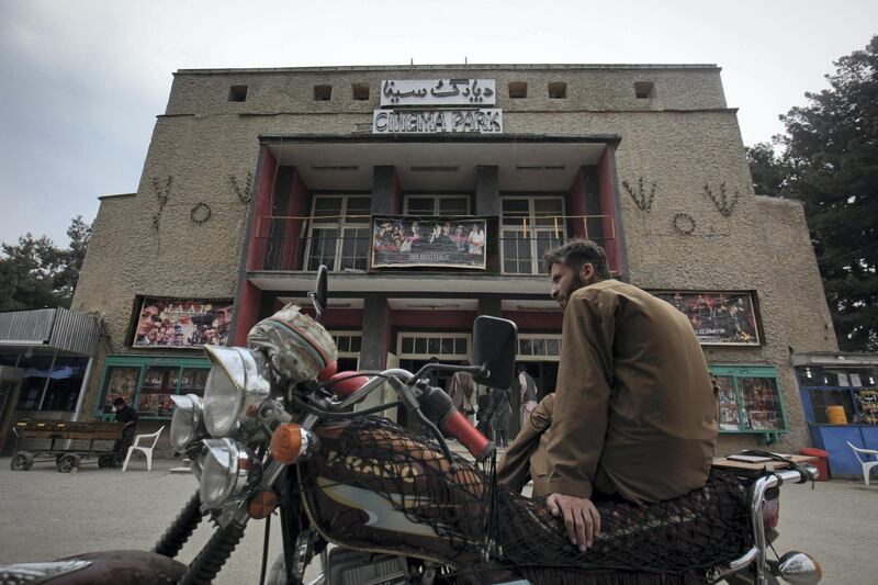 A man sits on a motorbike outside Cinema Park in Kabul May 5, 2012. Once a treasured luxury for the elite, Afghan cinemas are dilapidated and reflect an industry on the brink of collapse from conflict and financial neglect. Kabul's cinemas show Pakistani films in Pashto, American action films and Bollywood to rowdy, largely unemployed crowds in pursuit of any distraction from their drab surroundings. Picture taken May 5, 2012. REUTERS/Danish Siddiqui (AFGHANISTAN - Tags: SOCIETY ENTERTAINMENT TRANSPORT)
ATTENTION EDITORS - PICTURE 01 OF 26 FOR PACKAGE 'KABUL'S SILVER SCREEN'