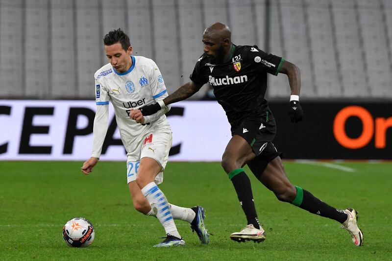 Marseille's Florian Thauvin under pressure from Seko Fofana of Lens. AFP