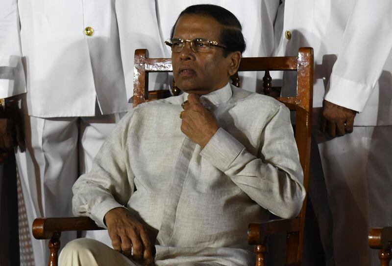 CORRECTION / Sri Lanka's President Maithripala Sirisena (C) waits next to Navy officers for a group photo during a ceremony commissioning P 626 ship, U.S gifted to the Sri Lankan coastguard at the main port in Colombo on June 6, 2019. The vessels are to be used to help merchant shipping and protect the islands coastline. / AFP / LAKRUWAN WANNIARACHCHI
