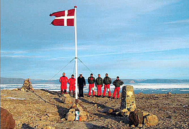 A group of Danish soldiers stand by the Danish flag on Hans Island, in this file picture. AFP