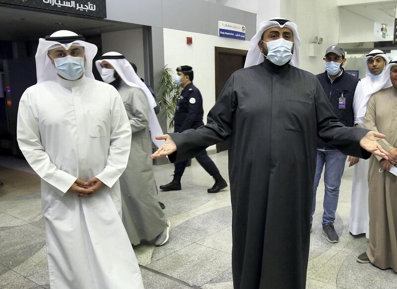 Kuwaiti health minister Sheikh Basel al-Sabah (R) speaks to the press at Sheikh Saad Airport in Kuwait City, on February 22, 2020, as Kuwaitis returning from Iran wait before being taken to a hospital to be tested for coronavirus. - Iran ordered the closure of schools, universities and cultural centres after a coronavirus outbreak that has killed five people in the Islamic republic, the most outside the Far East. (Photo by YASSER AL-ZAYYAT / AFP)