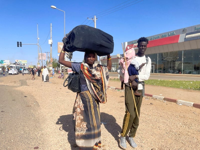 People flee Khartoum during clashes between the paramilitary RSF and the army on April 19. Reuters