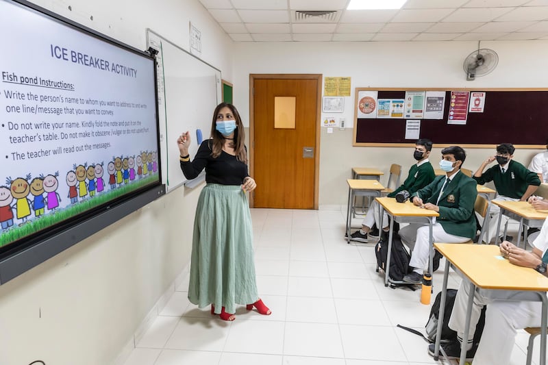 A teacher leads a welcome back activity at the Delhi Private School.