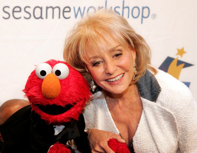 Walters and Elmo the Muppet at the Sesame Workshop Awards Dinner in 2005. EPA 