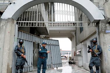 Afghan policemen guard the gate of a Sikh place of worship in Kabul after an attack on March 25, 2020 that was claimed by ISIS. Reuters