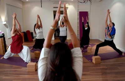 Nouf Marwaai, 38, the head of the Arab Yoga Foundation (foreground), instructs her yoga students with at her studio in the western Saudi Arabian city of Jeddah on September 7, 2018. Widely perceived as a Hindu spiritual practice, yoga was not officially permitted for decades in Saudi Arabia, the cradle of Islam where all non-Muslim worship is banned. But with Crown Prince Mohammed bin Salman vowing an "open, moderate Islam", the kingdom last November recognised yoga as a sport, despite the risk of riling hardliners opposed to the practice. / AFP / Amer HILABI
