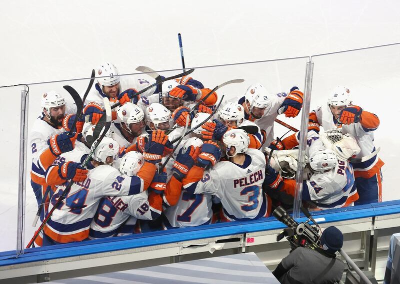 Jordan Eberle, No 7, is mobbed by New York Islanders teammates after scoring the winner against Tampa Bay Lightning during the second overtime period in Game 5 of the NHL Stanley Cup Play-offs Eastern Conference final at Rogers Place in Edmonton, Canada, on Tuesday, September 15. AFP