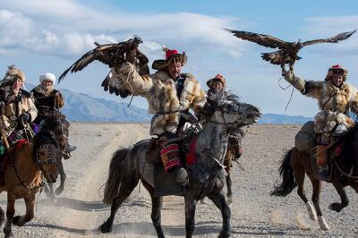 MONGOLIA - 2017/10/01: A group of Kazakh Eagle hunters and their Golden eagles on horseback on the way to the Golden Eagle Festival near the city of Ulgii (Ölgii) in the Bayan-Ulgii Province in western Mongolia. (Photo by Wolfgang Kaehler/LightRocket via Getty Images)