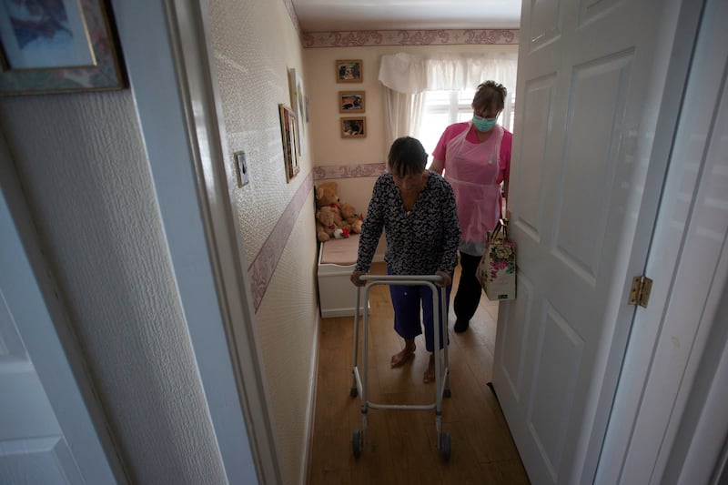 Dawn, a carer from Elite Care Solutions, tends to her client Tina, who suffers from MS. AFP