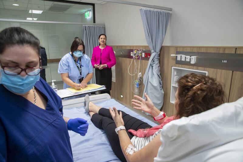 Queensland Premier Annastacia Palaszczuk, centre rear, speaks to volunteers during a coronavirus vaccine development announcement in Brisbane, Australia. Ms Palaszczuk said it was an exciting day for Queensland as human trials have begun for a potential Covid-19 vaccine, which is developed by the University of Queensland.  EPA