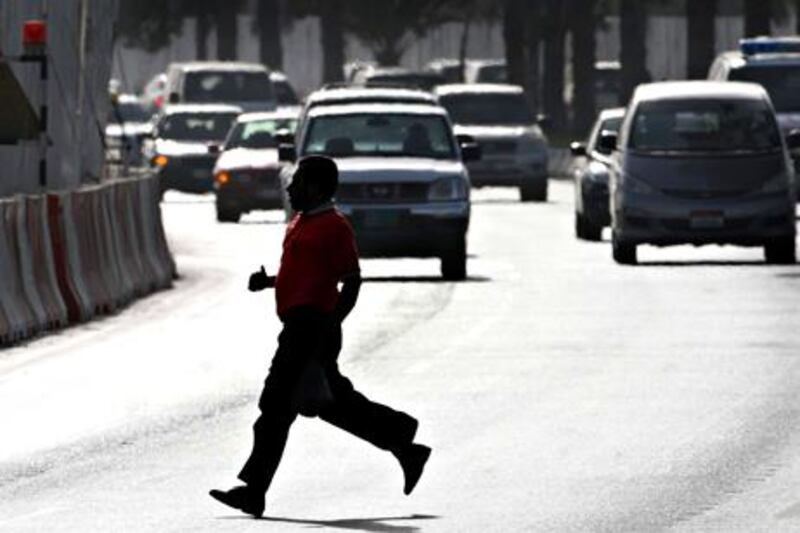 ABU DHABI. 1st Juy. 2009. Run the gauntlet...A Pedestrian crosses the Airport road outside Carrefour, Abu Dhabi yesterday(weds). Stephen Lock  /  The National . 