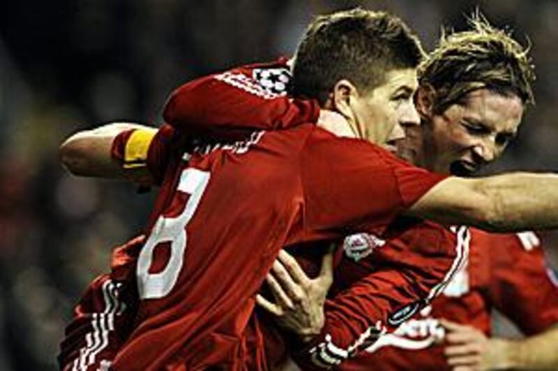 The Liverpool captain Steven Gerrard, left, celebrates with a delighted Fernando Torres after his penalty to make it to 2-0 against Real Madrid.
