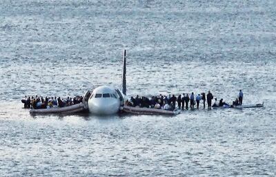 In this Thursday Jan. 15, 2009 file photo, airline passengers wait to be rescued on the wings of a US Airways Airbus 320 jetliner that safely ditched in the frigid waters of the Hudson River in New York, after a flock of birds knocked out both its engines. The audio recordings of US Airways Flight 1549, released Thursday, Feb 5, 2009 by the Federal Aviation Administration, reflect the initial tension between tower controllers and the cockpit and then confusion about whether the passenger jet went into the river. (AP Photo/Steven Day) ** EDITORS NOTE RESTRICTIONS: TO USE THIS IMAGE IN AN EDITORIAL MAGAZINE, PLEASE CONTACT YOUR AP IMAGES LICENSING REPRESENTATIVE. SPECIAL RATES APPLY **