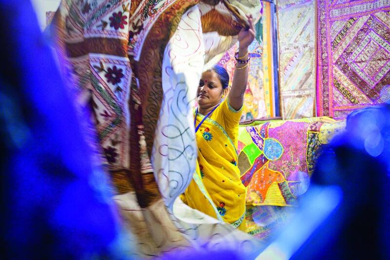 Seema Ganesh Lal, a saleswoman from India stands at her stall at the India pavilion of Global Village. She sells rugs from Gujurat and other Indian states. Razan Alzayani / The National