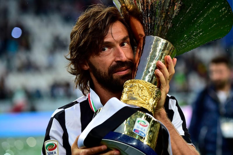 Andrea Pirlo poses with the Italian League's trophy in 2015. AFP