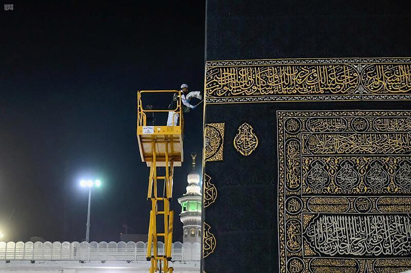 A worker cleans and sterilises the roof of Kaaba at the Grand Mosque  in Saudi city of Makkah amid the outbreak of the coronavirus on April 21, 2020. Saudi Press Agency handout via Reuters