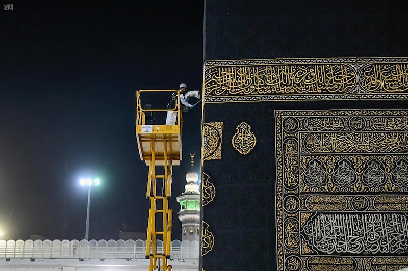 A worker cleans and sterilises the roof of Kaaba at the Grand Mosque  in Saudi city of Makkah amid the outbreak of the coronavirus on April 21, 2020. Saudi Press Agency handout via Reuters