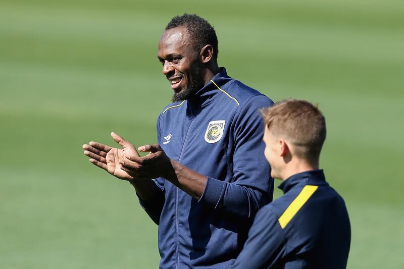 Usain Bolt warms speaks with a teammate. Getty Images