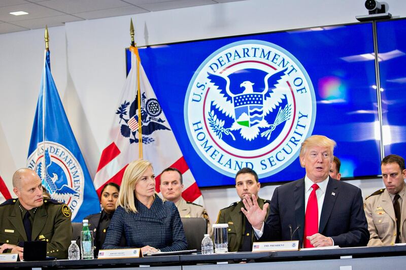 epa06492918 US President Donald J. Trump (R) speaks as Kirstjen Nielsen, secretary of Homeland Security,(C-L), listens while participating in a Customs and Border Protection (CBP) roundtable discussion after touring the CBP National Targeting Center in Sterling, Virginia, USA, 02 February 2018. President Trump visits the Customs and Border Protection (CBP) National Targeting Center to highlight his proposals to bolster the country’s borders.  EPA/ANDREW HARRER / POOL