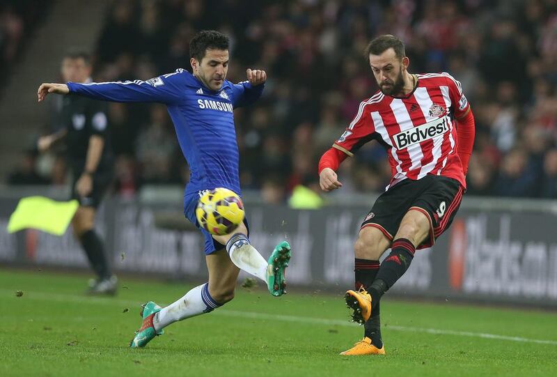 Chelsea midfielder Cesc Fabregas vies with Sunderland striker Steven Fletcher during their English Premier League match at the Stadium of Light in Sunderland, north east England on November 29, 2014. The game finished 0-0. AFP PHOTO / IAN MACNICOL